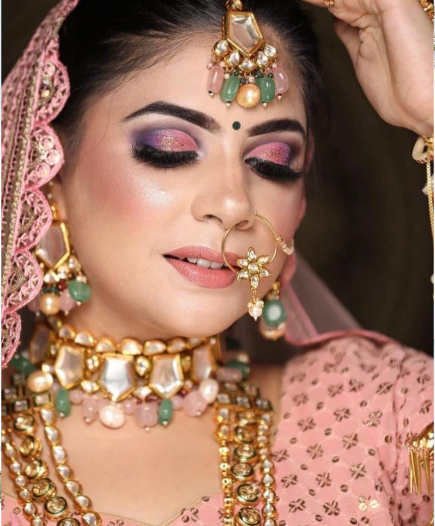 Bride with full bridal makeup and jewellery, done at Glamin Salon