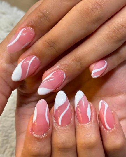 Nail extensions with white swirl art, done at Glamin Salon