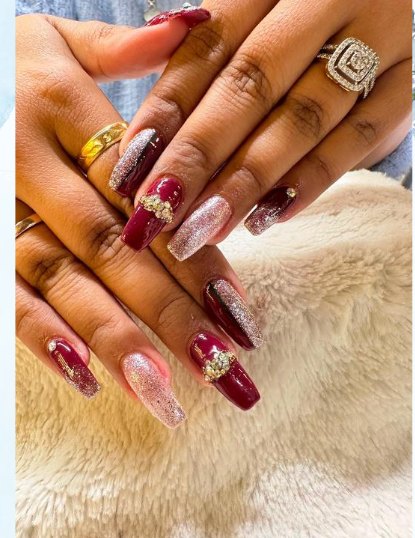Burgundy and glitter nail extensions done at Glamin Salon